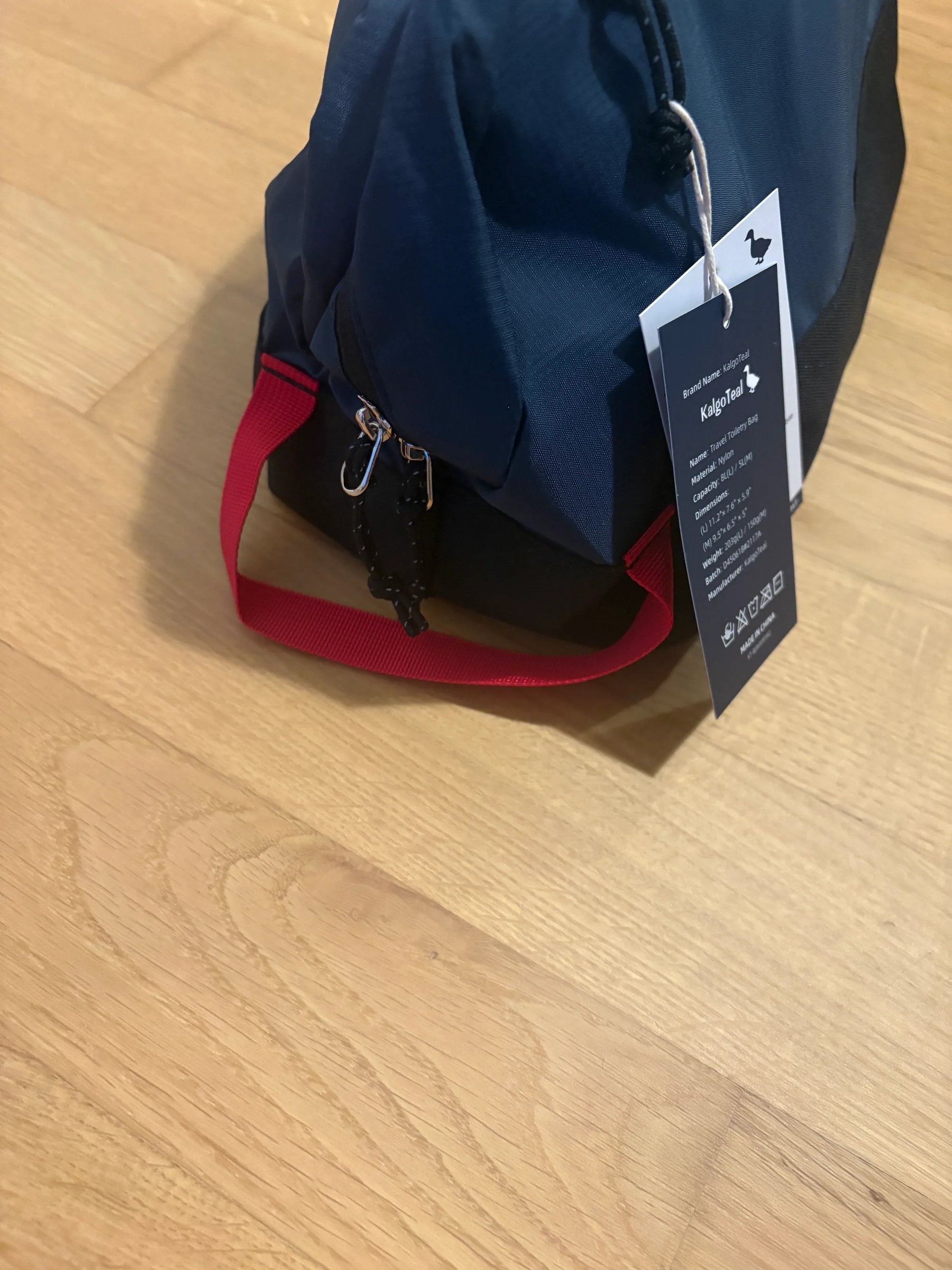 Side view of the wash bag showing the carry handle